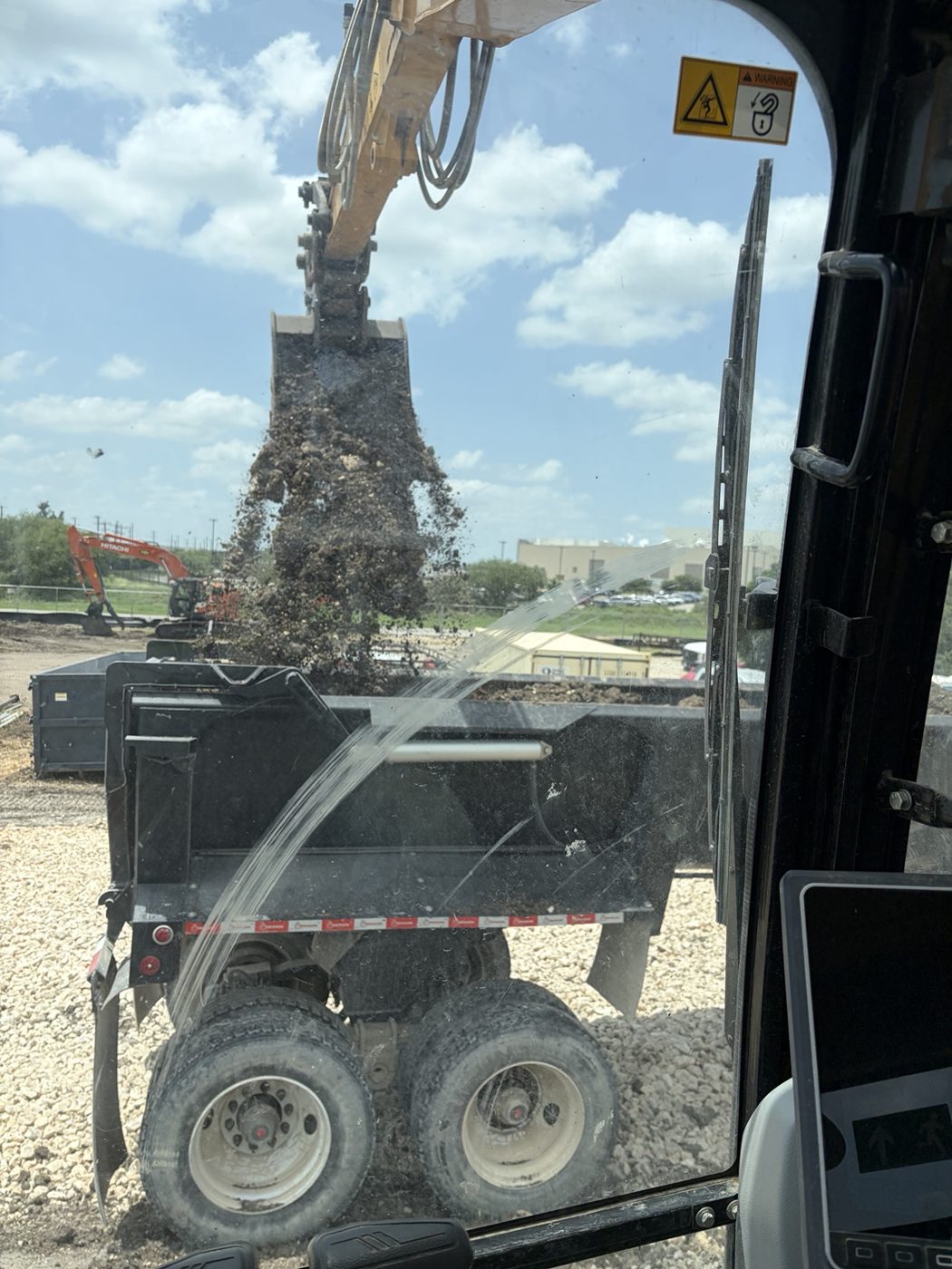 Excavator loading dump trailer