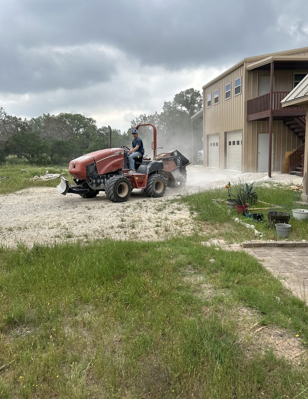 Tractor with Harley rake grading gravel driveway